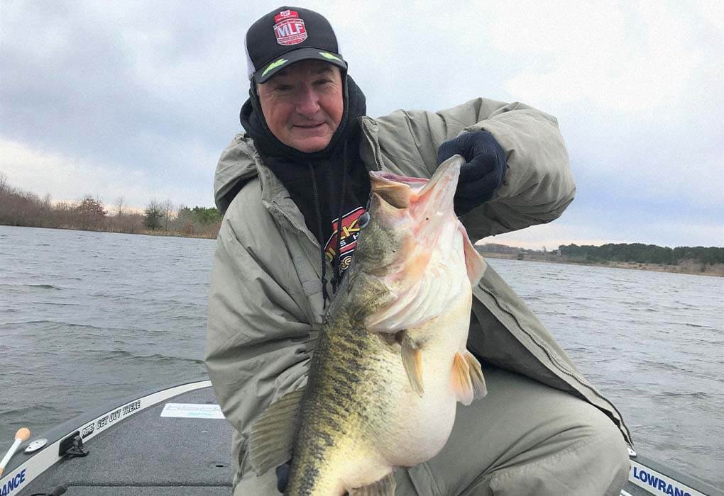 Gary Klein posed with the 13.79-pound bass he caught on a private lake in Texas. (Photo courtesy of Gary Klein)