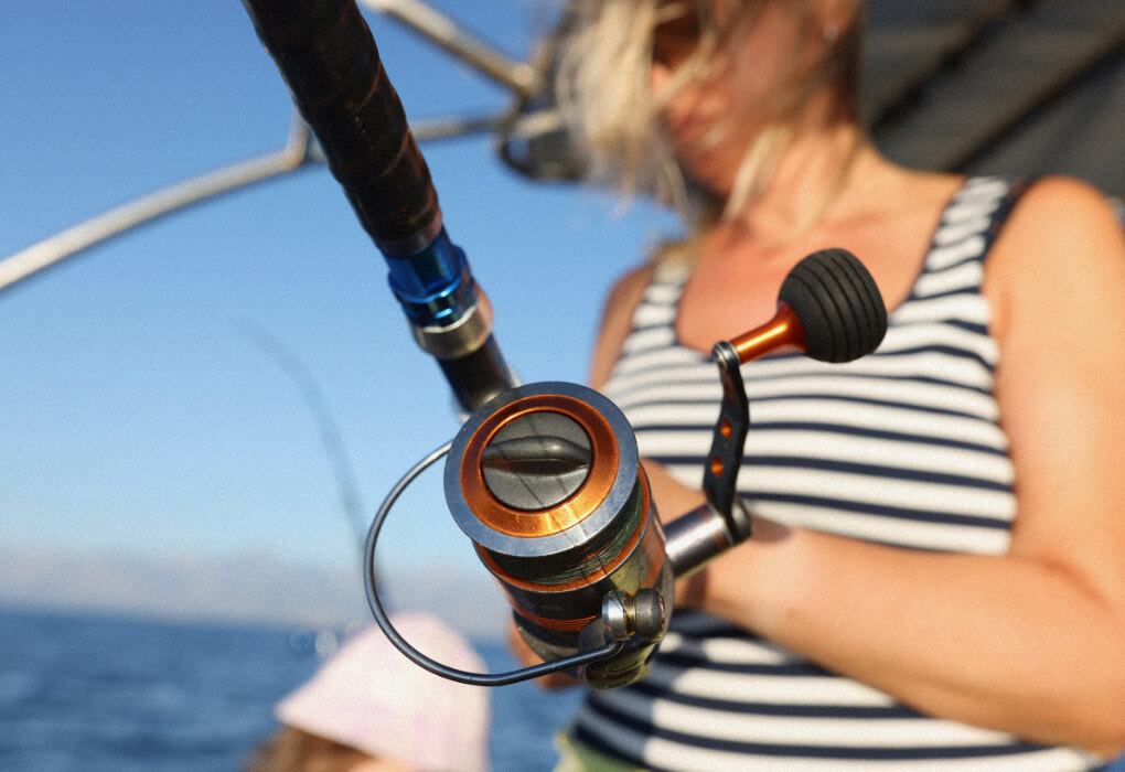woman fishing with a rod and a spinning reel for saltwater